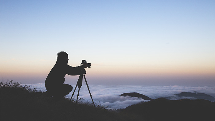 The three pillars, are sometimes referred to as the tripod of Scrum. Just like a camera without a tripod, Scrum teams need all three pillars to stay steady and capture the perfect shot. A silhouette of a photographer setting up the camera to shoot the sea of clouds during sunset